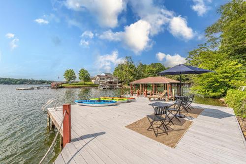a dock with chairs and tables and a pavilion on the water at Lake Hickory Trio 2BR Green Unit in Hickory