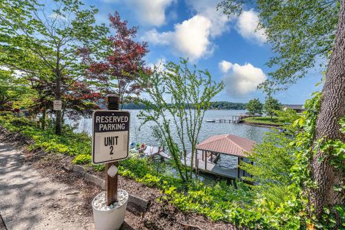 a restricted parking sign in front of a lake at Lake Hickory Trio 2BR Green Unit in Hickory