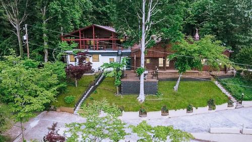 an aerial view of a house in the woods at Lake Hickory Trio 2BR Green Unit in Hickory