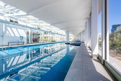a large swimming pool in a building with water at Views for Days - Luxe 4BR Stay with Pool & Hot Tub in Melbourne