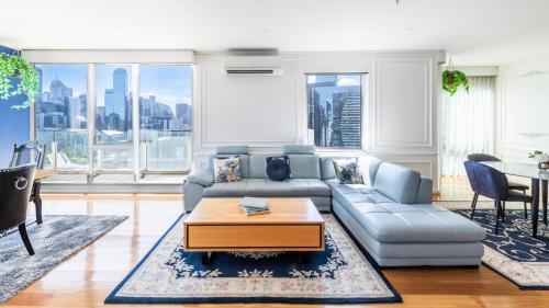 a living room with a couch and a table at Views for Days - Luxe 4BR Stay with Pool & Hot Tub in Melbourne
