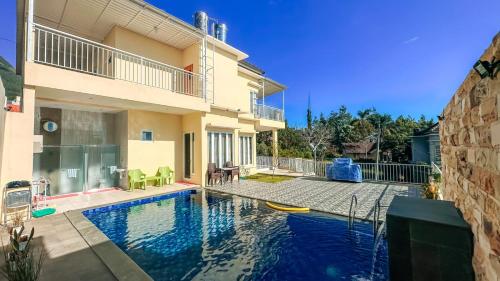 a swimming pool in the backyard of a house at SpringHills Villa Panderman Batu - Private Pool in Tlekung