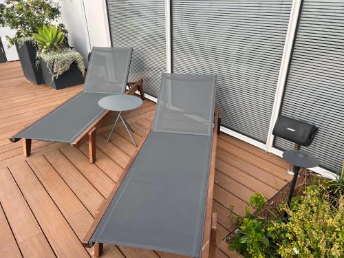two chairs and a table on a deck at Mafruma in H̱adera