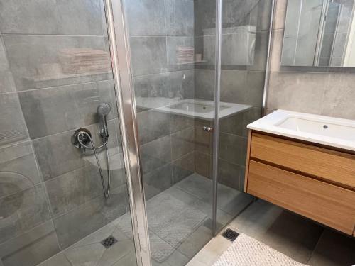 a bathroom with a shower and a sink at Mafruma in H̱adera