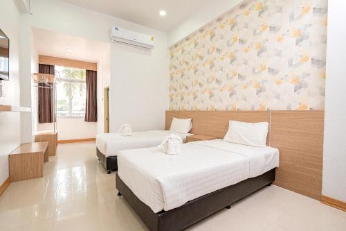 Postel nebo postele na pokoji v ubytování Top Inn Hotel พร้อมอาหารเช้า ใกล้วัดป่าวังน้ำเย็นและสถานที่ท่องเที่ยว