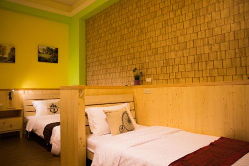 two beds in a room with yellow walls at 輕旅小站 Soft Travel Hostel in Taitung City