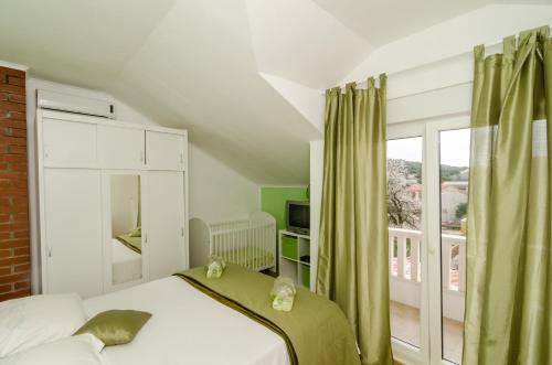 a bedroom with a bed and a large window at Holiday Home Tina in Cavtat