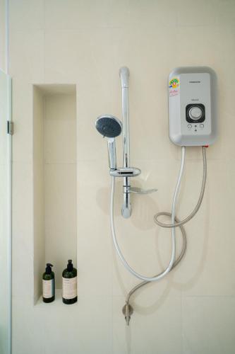a bathroom with a blow dryer on the wall at Winvilla Pattaya - Private Pool Villa 5 Bedrooms in Na Jomtien