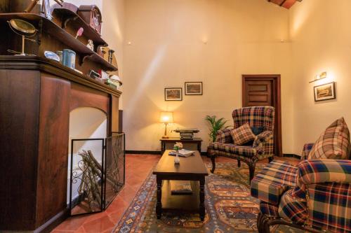 a living room with a couch and a fireplace at The Hallery By Old Kent in Madikeri