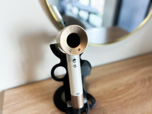 a fake gun sitting on a wooden floor with a mirror at Tulip Residences by Manhattan Group in Shah Alam