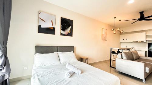 a bedroom with a bed and a living room at Tulip Residences by Manhattan Group in Shah Alam