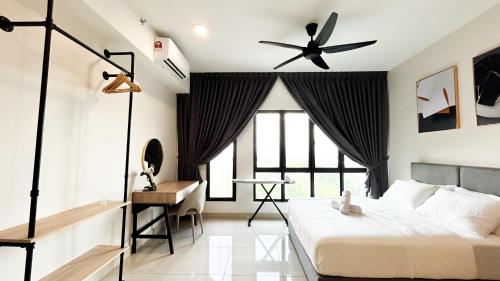 a bedroom with a bed and a ceiling fan at Tulip Residences by Manhattan Group in Shah Alam