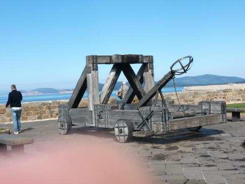 a man walking past a wooden truck statue at Sardinia rooms in Alghero