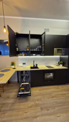 a kitchen with a counter and a wooden table at Räpina Studio Apartment in Räpina