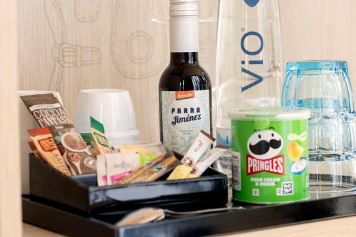 a bottle of wine sitting next to a container of food at Scandic Hamburg Emporio in Hamburg