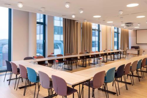 a large conference room with tables and chairs at Scandic Hamburg Emporio in Hamburg