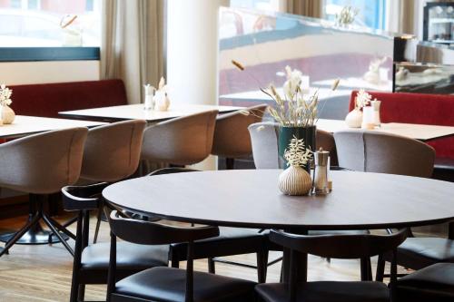 a row of tables and chairs in a restaurant at Scandic Hamburg Emporio in Hamburg