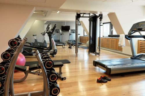 a gym with treadmills and exercise equipment on a wooden floor at Scandic Copenhagen in Copenhagen