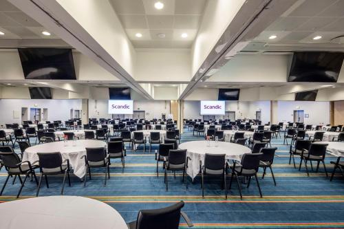 a large room with tables and chairs in it at Scandic Copenhagen in Copenhagen
