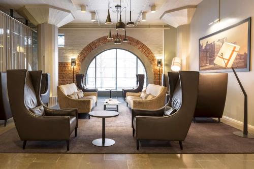 a waiting room with chairs and a table at Scandic Grand Marina in Helsinki