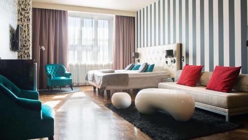 a living room with a couch and a table at Scandic Paasi in Helsinki
