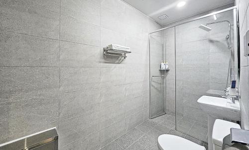 a bathroom with a shower and a toilet and a sink at Nobotel Cheonan in Cheonan