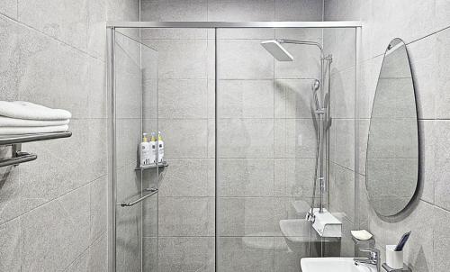 a bathroom with a shower and a sink at Nobotel Cheonan in Cheonan
