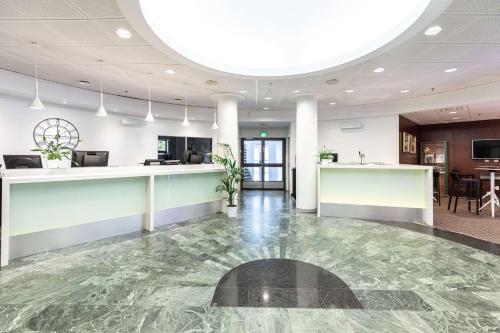 an office lobby with a marble floor and a reception counter at Scandic Patria in Lappeenranta