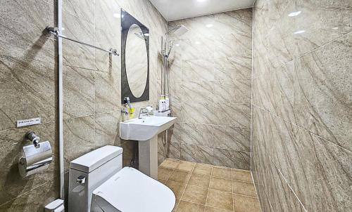 a bathroom with a toilet and a sink and a mirror at Nobotel Cheonan in Cheonan