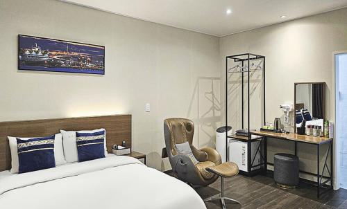 a bedroom with a bed and a desk and a chair at Nobotel Cheonan in Cheonan