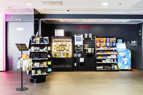 a store with a shop sign on a black wall at Scandic Tampere Station in Tampere