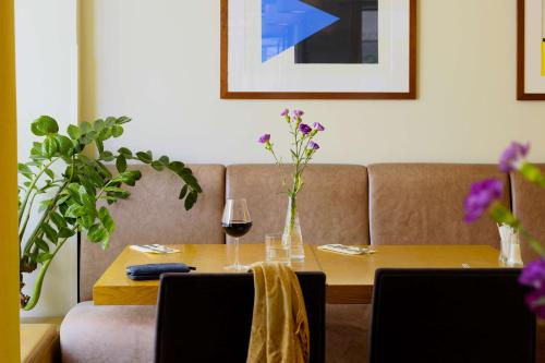 a table with a vase of flowers on top of it at Scandic Plaza Turku in Turku