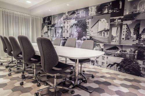 a conference room with a white table and chairs at Scandic Plaza Turku in Turku