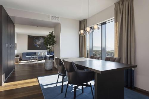 a dining room and living room with a table and chairs at Scandic Havet in Bodø