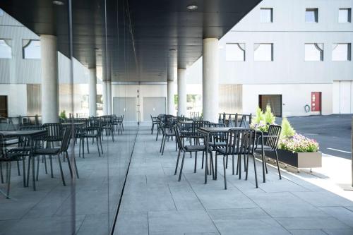 a row of tables and chairs in a building at Scandic Hamar in Hamar