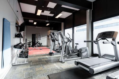 a gym with treadmills and elliptical machines at Scandic Hamar in Hamar
