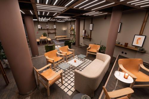 an overhead view of a waiting room with tables and chairs at Scandic Hamar in Hamar