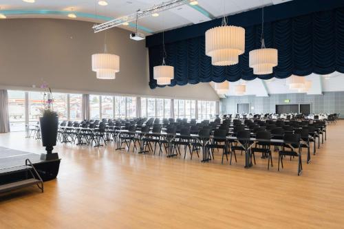 a large room with rows of tables and chairs at Scandic Hamar in Hamar