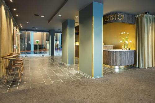 a lobby with a reception desk in a building at Scandic St. Olavs Plass in Oslo