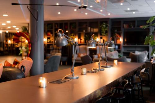 a long table in a restaurant with candles on it at Scandic Byporten in Oslo