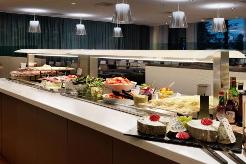 a buffet line with many different types of food at Scandic Oslo Airport in Gardermoen