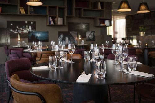 a table in a restaurant with wine glasses on it at Scandic Oslo Airport in Gardermoen