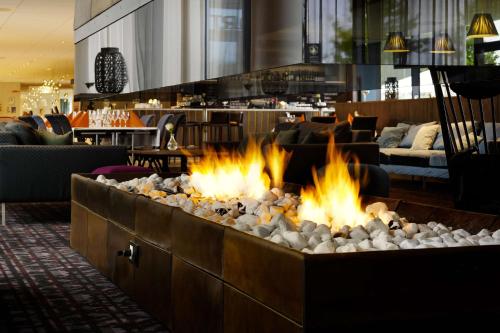 a fire pit in the lobby of a hotel at Scandic Oslo Airport in Gardermoen