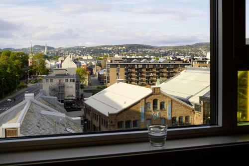 a window with a view of a city at Scandic Solsiden in Trondheim