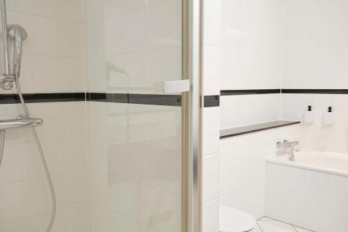 a bathroom with a shower and a sink at Scandic Wrocław in Wrocław