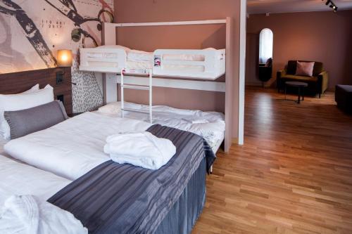 a bedroom with two bunk beds and a living room at Scandic Plaza Borås in Borås