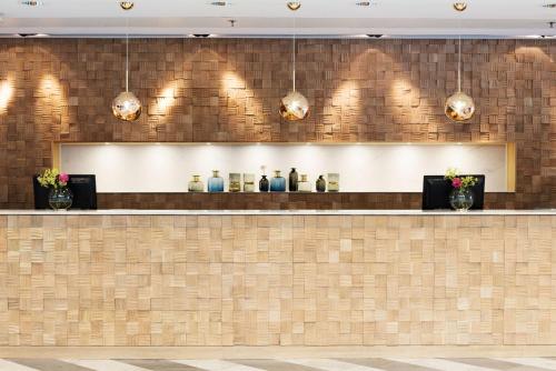 a bar in a restaurant with lights on the wall at Scandic Crown in Gothenburg