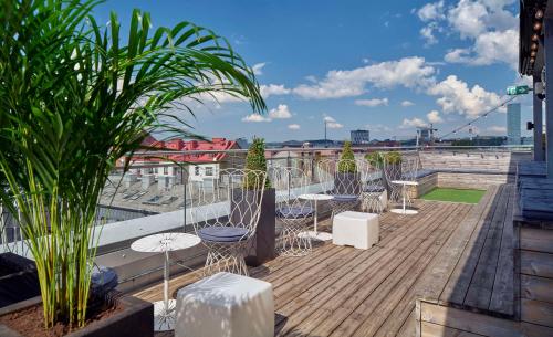 a patio with tables and chairs on a roof at Scandic Rubinen in Gothenburg