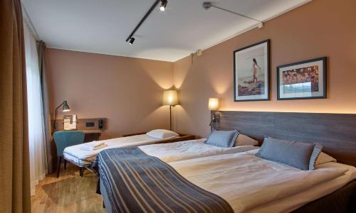 a hotel room with two beds in a room at Scandic CH in Gävle