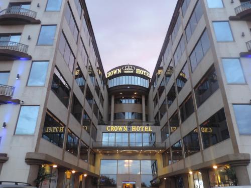 a large building with a clock on it at Crown Hotel Juba in Juba
